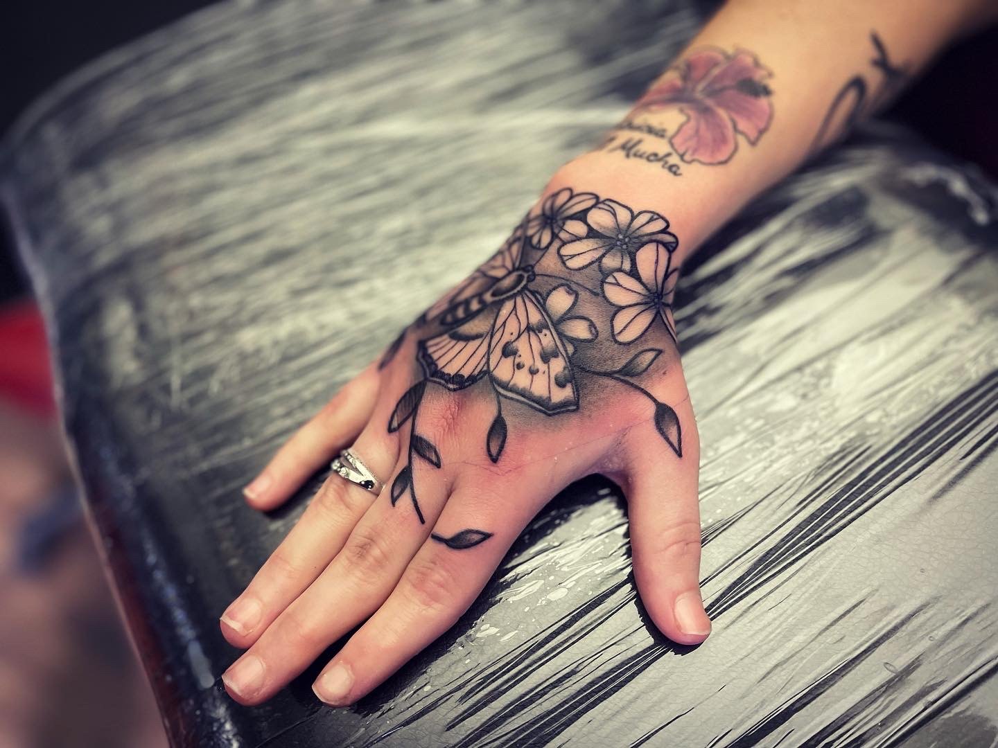 Moth hand tattoo