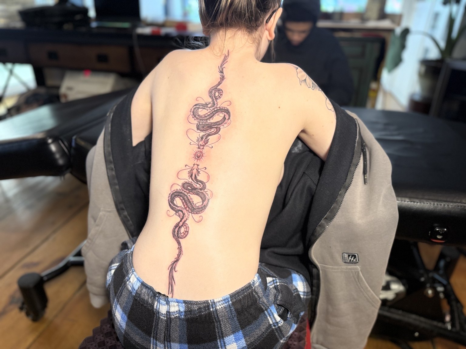 Snake tattoo running down the spine