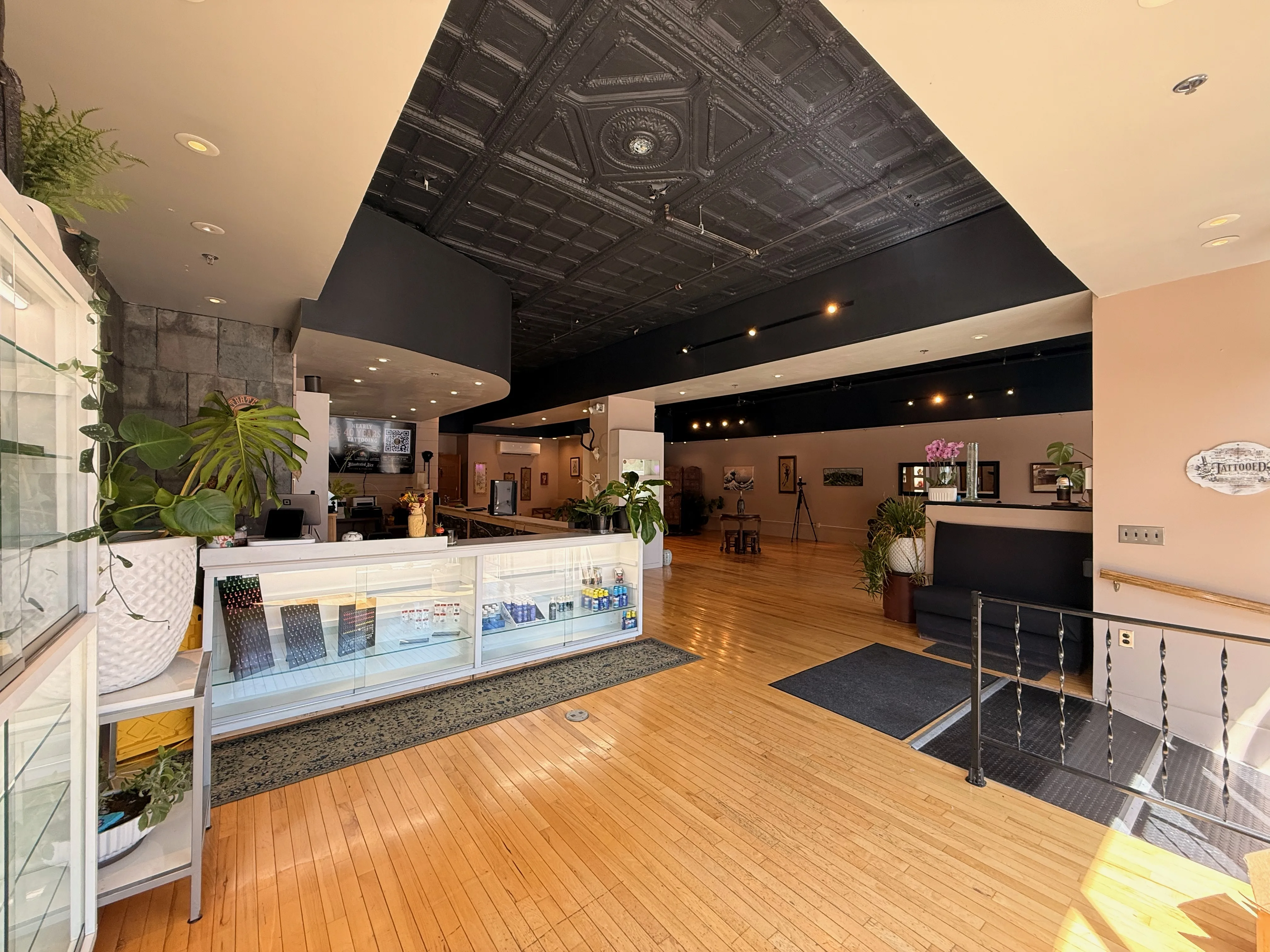 Open studio interior with hardwood floors and comfortable waiting area